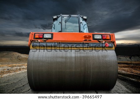 stock-photo-road-roller-on-the-old-highway-untill-a-big-strom-approaching-39665497.jpg
